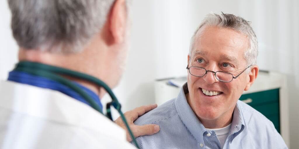 what-does-the-cornea-do-1024x512 Senior man with eye glasses talking with his doctor.